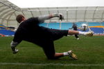 GOLD COAST, AUSTRALIA - JULY 07:  Archie Thompson of the Melbourne Victory attempts to get the ball past goalkeeper Mark Schwarzer of Fulham FC after a Fulham training session at Skilled Stadium on July 7, 2009 in Gold Coast, Australia.  (Photo by Bradley Kanaris/Getty Images)
