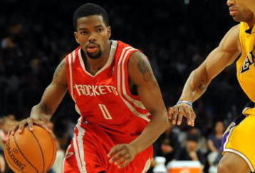 LOS ANGELES, CA - MAY 06:  Aaron Brooks #0 of the Houston Rockets moves the ball against Derek Fisher #2 of the Los Angeles Lakers in Game Two of the Western Conference Semifinals during the 2009 NBA Playoffs at Staples Center on May 6, 2009 in Los Angeles, California. NOTE TO USER: User expressly acknowledges and agrees that, by downloading and or using this photograph, User is consenting to the terms and conditions of the Getty Images License Agreement.  (Photo by Harry How/Getty Images)