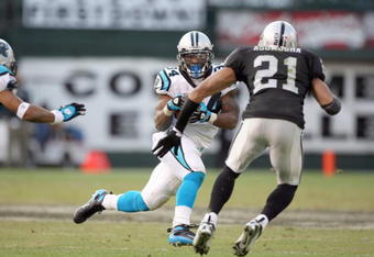 OAKLAND - NOVEMBER 9:  DeAngelo Williams #34 of the Carolina Panthers carries the ball against Nnamdi Asomugha #21 of the Oakland Raiders at the Oakland-Alameda County Coliseum on November 9, 2008 in Oakland, California. (Photo by: Jed Jacobsohn/Getty Images)