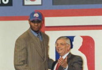 24 Jun 1998: A picture of the 1st Pick Michael Olowokandi by the Los Angeles Clippers shaking hands with David Stern the NBA Commissioner during the NBA Draft at the General Motors Palace in Vancouver, Canada. FOR EDITORIAL USE ONLY