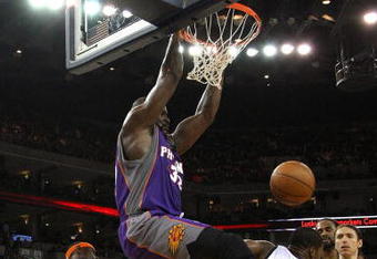 OAKLAND, CA - MARCH 15:  Shaquille O'Neal #32 of the Phoenix Suns dunks over Kelenna Azubuike #7 of the Golden State Warriors during an NBA game on March 15, 2009 at Oracle Arena in Oakland, California. NOTE TO USER: User expressly acknowledges and agrees that, by downloading and or using this photograph, User is consenting to the terms and conditions of the Getty Images License Agreement.  (Photo by Jed Jacobsohn/Getty Images)