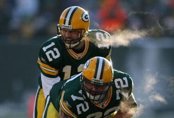 GREEN BAY, WI - DECEMBER 28: Aaron Rodgers #12 of the Green Bay Packers awaits the snap from George Foster #72 during a game against the Detroit Lions on December 28, 2008 at Lambeau Field in Green Bay, Wisconsin. The Packers defeated the Lions 31-21.  (Photo by Jonathan Daniel/Getty Images)