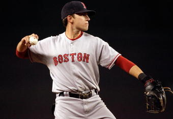 NEW YORK - AUGUST 27:  Jed Lowrie #12 of the Boston Red Sox warms up between innings against the New York Yankees on August 27, 2008 at Yankee Stadium in the Bronx borough of New York City. The Red Sox defeated the Yankees 11-3.  (Photo by Jim McIsaac/Getty Images)