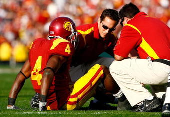 PASADENA, CA - JANUARY 01:  Tailback Joe McKnight #4 of the USC Trojans is attended to by trainers after getting injured in the first half against the Penn State Nittany Lions during the 95th Rose Bowl Game presented by Citi on January 1, 2009 at the Rose Bowl in Pasadena, California.  (Photo by Jeff Gross/Getty Images)