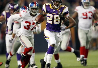 MINNEAPOLIS - DECEMBER 28:   Adrian Peterson #28 of the Minnesota Vikings runs the ball in for a touchdown as James Butler of the New York Giants defends on December 28, 2008 at the Hubert H. Humphrey Metrodome in Minneapolis, Minnesota. The Vikings defeated the Giants 20-19. (Photo by Elsa/Getty Images)