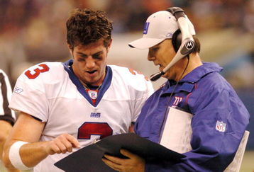 NEW ORLEANS - DECEMBER 14:  Jesse Palmer #3 of the New York Giants speaks with quarterback coach Turk Schonert during the 4th quarter against the New Orleans Saints on December 14, 2003 at the Superdome in New Orleans, Louisiana. The Saints defeated the Giants 45-7.  (Photo by Chris Graythen/Getty Images)