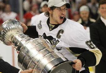 DETROIT - JUNE 12:  Sidney Crosby #87 of the Pittsburgh Penguins holds the Stanley Cup following the Penguins victory over the Detroit Red Wings in Game Seven of the 2009 NHL Stanley Cup Finals at Joe Louis Arena on June 12, 2009 in Detroit, Michigan.  (Photo by Bruce Bennett/Getty Images)