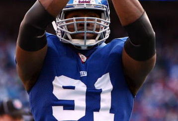 EAST RUTHERFORD, NJ - JANUARY 11:  Justin Tuck #91 of the New York Giants reacts after a saftey against the Philadelphia Eagles during the NFC Divisional Playoff Game on January 11, 2009 at Giants Stadium in East Rutherford, New Jersey.  (Photo by Al Bello/Getty Images)
