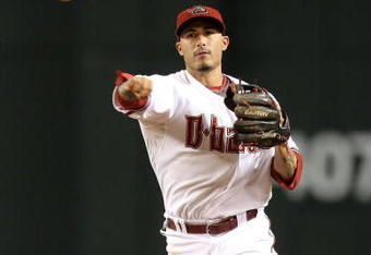 PHOENIX - JULY 10:  Infielder Felipe Lopez #2 of the Arizona Diamondbacks fields a ground ball out against the Florida Marlins during the major league baseball game at Chase Field on July 10, 2009 in Phoenix, Arizona. The Diamondbacks defeated the Marlins 8-0.  (Photo by Christian Petersen/Getty Images)