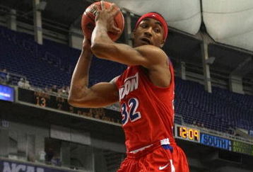 MINNEAPOLIS - MARCH 22:  Marcus Johnson #32 of the Dayton Flyers grabs a defensive rebound in the first half against the Kansas Jayhawks during the second round of the NCAA Division I Men's Basketball Tournament at the Hubert H. Humphrey Metrodome on March 22, 2009 in Minneapolis, Minnesota.  (Photo by Jonathan Daniel/Getty Images)