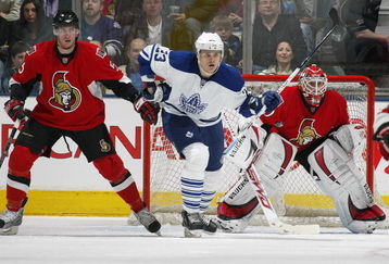 TORONTO - APRIL 11:  Alexei Ponikarovsky #23 of the Toronto Maple Leafs looks to deflect a shot between Christoph Schubert #5 and Brian Elliott #30 of the Ottawa Senators in a game on April 11, 2009 at the Air Canada Centre in Toronto, Ontario. The Leafs defeated the Senators on the strength of a 3 goal performance by Boyd Devereaux #22. (Photo by Claus Andersen/Getty Images) 