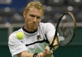 ROTTERDAM, NETHERLANDS - FEBRUARY 12:  Dmitry Tursunov of Russia plays a backhand during his match against Jo-Wilfried Tsonga of France during day four of the ABN AMRO World Tennis Tournament at the Ahoy Centre Rotterdam on February 12, 2009 in Rotterdam, Netherlands.  (Photo by Hamish Blair/Getty Images)