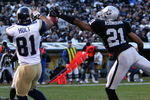 Oakland cornerback Nnamdi Asomugha prevents a touchdown by perfectly deflecting a pass away from St. Louis wide receiver Torry Holt in the Raiders 20-0 loss to the Rams on Sunday, December 17, 2006 at McAfee Coliseum in Oakland, California. (Photo by K. Terrell/Getty Images)