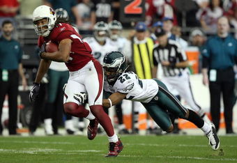 GLENDALE, AZ - JANUARY 18:  Wide receiver Larry Fitzgerald #11 of the Arizona Cardinals attempts to run by a tackle attempt by cornerback Asante Samuel #22 of the Philadelphia Eagles during the NFC championship game on January 18, 2009 at University of Phoenix Stadium in Glendale, Arizona.  (Photo by Jed Jacobsohn/Getty Images)