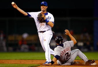 KANSAS CITY, MO - MAY 13:  Mark Grudzielanek #15 of the Kansas City Royals turns a double play as Ivan Rodriguez #7 of the Detroit Tigers slides into second during the 5th inning of the game on May 13, 2008 at Kauffman Stadium in Kansas City, Missouri.  (Photo by Jamie Squire/Getty Images)