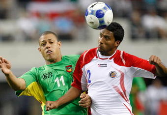 ARLINGTON, TX - JULY 19:  Midfielder David Fleurival #11 of Guadeloupe battles for a header with Dario Delgado #2 of Costa Rica during the CONCACAF Gold Cup Quarterfinals at Dallas Cowboys Stadium on July 19, 2009 in Arlington, Texas.  (Photo by Ronald Martinez/Getty Images)