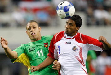 ARLINGTON, TX - JULY 19:  Midfielder David Fleurival #11 of Guadeloupe battles for a header with Dario Delgado #2 of Costa Rica during the CONCACAF Gold Cup Quarterfinals at Dallas Cowboys Stadium on July 19, 2009 in Arlington, Texas.  (Photo by Ronald Martinez/Getty Images)