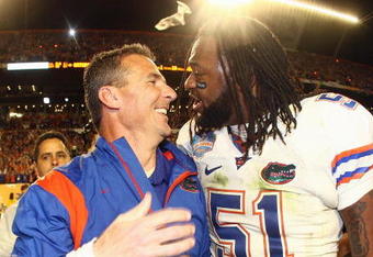 MIAMI - JANUARY 08:  Head coach Urban Meyer of the Florida Gators celebrates with Brandon Spikes #51 their win over the Oklahoma Sooners after the FedEx BCS National Championship Game at Dolphin Stadium on January 8, 2009 in Miami, Florida.  (Photo by Donald Miralle/Getty Images)