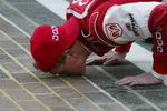 INDIANAPOLIS - AUGUST 4:  Bill Elliott, driver of the #9 Evernham Motorsports Dodge intrepid R\T, kisses the bricks after winning the NASCAR Winston Cup Brickyard 400 on  August 4, 2002 during  at Indianapolis Motor Speedway in Indianapolis, Indiana. (Photo by Jonathan Ferrey/Getty Images)