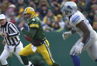 10 Dec 2000:  Brett Favre #4 of the Green Bay Packers is chased out of the pocket by Robert Porcher #91 of the Detroit Lions at Lambeau Field in Green Bay, Wisconsin. <DIGITAL IMAGE> Mandatory Credit: Matthew Stockman/ALLSPORT
