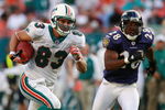 MIAMI - DECEMBER 16:  Wide receiver Greg Camarillo #83 of the Miami Dolphins breaks away from defensive back Jamaine Winborne #28 of the Baltimore Ravens for the game winning touchdown in overtime at Dolphin Stadium on December 16, 2007 in Miami, Florida. The Dolphins defeated the Ravens 22-16 for their first victory of the year.  (Photo by Doug Benc/Getty Images)