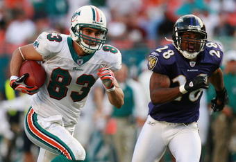 MIAMI - DECEMBER 16:  Wide receiver Greg Camarillo #83 of the Miami Dolphins breaks away from defensive back Jamaine Winborne #28 of the Baltimore Ravens for the game winning touchdown in overtime at Dolphin Stadium on December 16, 2007 in Miami, Florida. The Dolphins defeated the Ravens 22-16 for their first victory of the year.  (Photo by Doug Benc/Getty Images)