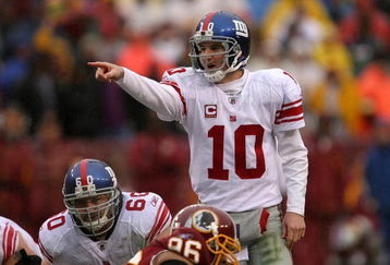LANDOVER, MD - NOVEMBER 30:  Eli Manning #10 of the New York Giants runs points to his team against the Washington Redskins during their game at FedEx Field on November 30, 2008 in Landover, Maryland.  (Photo by Streeter Lecka/Getty Images)