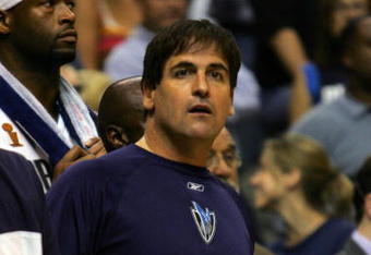 DALLAS - JUNE 20:  Owner Mark Cuban of the Dallas Mavericks looks on standing in the team bench in game six of the 2006 NBA Finals against the Miami Heat on June 20, 2006 at American Airlines Center in Dallas, Texas.  The Heat defeated the Mavericks 95-92 to win the NBA title. NOTE TO USER: User expressly acknowledges and agrees that, by downloading and or using this photograph, User is consenting to the terms and conditions of the Getty Images License Agreement.  (Photo by Stephen Dunn/Getty Images)
