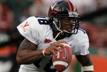 CORAL GABLES, FL - NOVEMBER 26:  Quarterback Marques Hagans #18 of the Virginia Cavaliers scrambles against the Miami Hurricanes at the Orange Bowl on November 26, 2005 in Coral Gables, Florida.  (Photo by Doug Benc/Getty Images)