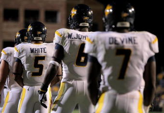 BOULDER, CO - SEPTEMBER 18:  Quarterback Pat White #5 of the West Virginia Mountaineers along with Will Johnson #6 and Noel Devine #7 line up in the back field against the Colorado Buffaloes at Folsom Field on September 18, 2008 in Boulder, Colorado. Colorado defeated West Virginia 17-14 in overtime.  (Photo by Doug Pensinger/Getty Images)