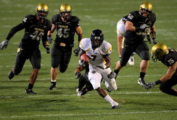 BOULDER, CO - SEPTEMBER 18:  Running back Noel Devine #7 of the West Virginia Mountaineers tries to elude the Colorado Buffaloes defense at Folsom Field September 18, 2008 in Boulder, Colorado. Colorado defeated West Virginia 17-14 in overtime.  (Photo by Doug Pensinger/Getty Images)