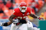 KANSAS CITY, MO - DECEMBER 14:  Larry Johnson #27 of the Kansas City Chiefs tries to break a tackle against the San Diego Chargers during the first half on December 14, 2008 at Arrowhead Stadium in Kansas City, Missouri. The Chiefs lost 22-21.  (Photo by Harry How/Getty Images)