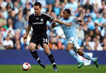 MANCHESTER, UNITED KINGDOM - SEPTEMBER 13:  Robinho of Manchester and John Terry of Chelsea battle for the ball during the Premier League match between Manchester City and Chelsea at The City of Manchester Stadium on September 13, 2008 in Manchester, England.  (Photo by Alex Livesey/Getty Images)