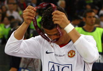 ROME - MAY 27:  Cristiano Ronaldo of Manchester United takes of his medal after Manchester United lost the UEFA Champions League Final match between Barcelona and Manchester United at the Stadio Olimpico on May 27, 2009 in Rome, Italy. Barcelona won 2-0. (Photo by Alex Livesey/Getty Images)