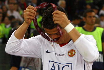 ROME - MAY 27:  Cristiano Ronaldo of Manchester United takes of his medal after Manchester United lost the UEFA Champions League Final match between Barcelona and Manchester United at the Stadio Olimpico on May 27, 2009 in Rome, Italy. Barcelona won 2-0. (Photo by Alex Livesey/Getty Images)