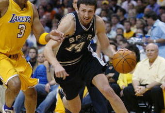 LOS ANGELES - MAY 11:  Hidayet Turkoglu #14 of the San Antonio Spurs drives on Devean George #3 of the Los Angeles Lakers in Game four of the Western Conference Semifinals during the 2004 NBA Playoffs at Staples Center on May 11, 2004 in Los Angeles, California.  The Lakers won 98-90.  NOTE TO USER: User expressly acknowledges and agrees that, by downloading and/or using this Photograph, user is consenting to the terms and conditions of the Getty Images License Agreement. (Photo by Lisa Blumenfeld/Getty Images)