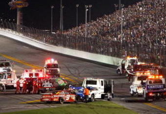 DAYTONA BEACH, FL - JULY 04:  Emergency vehicles tend to Kasey Kahne, driver of the #9 Budweiser Dodge, and Kyle Busch, driver of the #18 Interstate Batteries Toyota, after both cars collided during the final lap of the NASCAR Sprint Cup Series 51st Annual Coke Zero 400 at Daytona International Speedway on July 4, 2009 in Daytona Beach, Florida.  (Photo by Streeter Lecka/Getty Images)