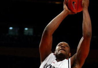 NEW YORK - MARCH 10:  Mac Koshwal #13 of the DePaul Blue Demons defends the shot of Yancy Gates #34 of the Cincinnati Bearcats during the first round of the Big East Tournament at Madison Square Garden on March 10, 2009 in New York City.  (Photo by Chris McGrath/Getty Images)
