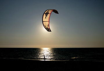 LEFKADA, GREECE - AUGUST 01:  Kiteboard fan practices on the sea of the Agios Giannis beach on August 1 2007, on Lefkada island, Greece. Kiteboarding becomes very fast world wide a new modern water sport.  (Photo by Vladimir Rys/Bongarts/Getty Images)