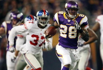 MINNEAPOLIS - DECEMBER 28:   Adrian Peterson #28 of the Minnesota Vikings runs the ball in for a touchdown as James Butler of the New York Giants defends on December 28, 2008 at the Hubert H. Humphrey Metrodome in Minneapolis, Minnesota. The Vikings defeated the Giants 20-19. (Photo by Elsa/Getty Images)