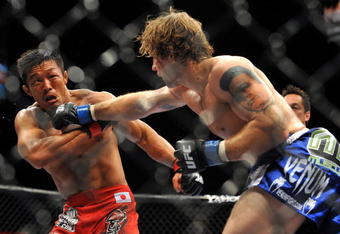 LAS VEGAS - JULY 11:  (R-L) Alan Belcher throws a right at Yoshihiro Akiyama during their middleweight bout during UFC 100 on July 11, 2009 in Las Vegas, Nevada.  (Photo by Jon Kopaloff/Getty Images)