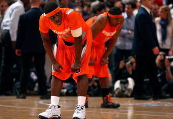 NEW YORK - MARCH 12:  Jonny Flynn #10 and Paul Harris #11 of the Syracuse Orange look on during the 4th overtime against the Connecticut Huskies during the quarterfinals of the Big East Tournament at Madison Square Garden on March 12, 2009 in New York City.  (Photo by Jim McIsaac/Getty Images)