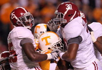 KNOXVILLE, TN - OCTOBER 25: Arian Foster #27 of the Tennessee Volunteers is tackled by Rolando McClain #25 and Dont'a Hightower #30 of the Alabama Crimson Tide during the game at Neyland Stadium on October 25, 2008 in Knoxville, Tennessee.  (Photo by Andy Lyons/Getty Images)