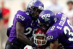 FORT WORTH, TX - SEPTEMBER 15:  Wide receiver Brent Casteel #6 of the Utah Utes is tackled by safeties Stephen Hodge #29 and Steven Coleman #38 of the Texas Christian University Horned Frogs on September 15, 2005 at Amon Carter Stadium in Fort Worth, Texas. TCU defeated Utah 23-20 in OT.  (Photo by Ronald Martinez/Getty Images)