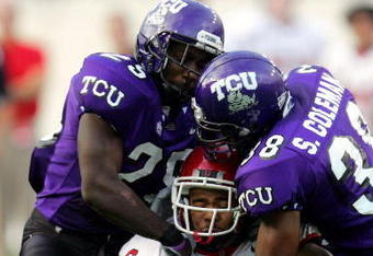 FORT WORTH, TX - SEPTEMBER 15:  Wide receiver Brent Casteel #6 of the Utah Utes is tackled by safeties Stephen Hodge #29 and Steven Coleman #38 of the Texas Christian University Horned Frogs on September 15, 2005 at Amon Carter Stadium in Fort Worth, Texas. TCU defeated Utah 23-20 in OT.  (Photo by Ronald Martinez/Getty Images)
