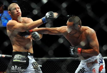 LAS VEGAS - JULY 11:  (R-L) Dan Henderson connects with a right to Mike Bisping during their middleweight bout during UFC 100 on July 11, 2009 in Las Vegas, Nevada.  (Photo by Jon Kopaloff/Getty Images)