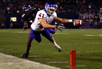 SAN DIEGO, CA - DECEMBER 23:  Runningback Ian Johnson #41 of the Boise State Broncos dives for the endzone pilon against the defense of Cornerback Rafael Priest #10 of TCU during the San Diego County Credit Union Poinsettia Bowl at Qualcomm Stadium on December 23, 2008 in San Diego, California. (Photo by Donald Miralle/Getty Images)