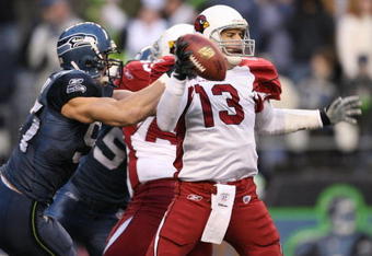 SEATTLE - DECEMBER 9:  Quarterback Kurt Warner #13 of the Arizona Cardinals is sacked by Patrick Kerney #97 of the Seattle Seahawks at Qwest Field December 9, 2007 in Seattle, Washington. The Seahawks defeated the Cardinals 42-21. (Photo by Otto Greule Jr/Getty Images)