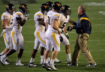 BOULDER, CO - SEPTEMBER 18:  Head coach Bill Stewart of the West Virginia Mountaineers leads his team against the Colorado Buffaloes at Folsom Field on September 18, 2008 in Boulder, Colorado. Colorado defeated West Virginia 17-14 in overtime.  (Photo by Doug Pensinger/Getty Images)