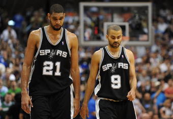 DALLAS - APRIL 25:  Forward Tim Duncan #21 and Tony Parker #9 of the San Antonio Spurs during a 99-90 loss against the Dallas Mavericks in Game Four of the Western Conference Quarterfinals during the 2009 NBA Playoffs at American Airlines Center on April 25, 2009 in Dallas, Texas. NOTE TO USER: User expressly acknowledges and agrees that, by downloading and or using this photograph, User is consenting to the terms and conditions of the Getty Images License Agreement.  (Photo by Ronald Martinez/Getty Images)